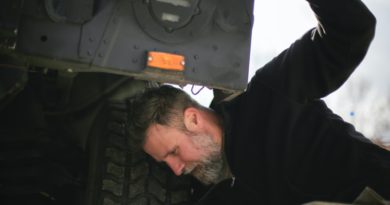 Person checking their tyres for signs