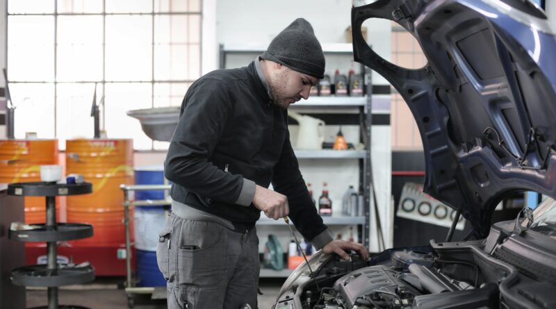 Person working on a vehicle inspection
