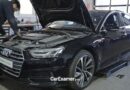 Audi Maintenance Schedule Explained: A Complete UK Service Guide audi model on the ramp and a man carry out basic maintenance