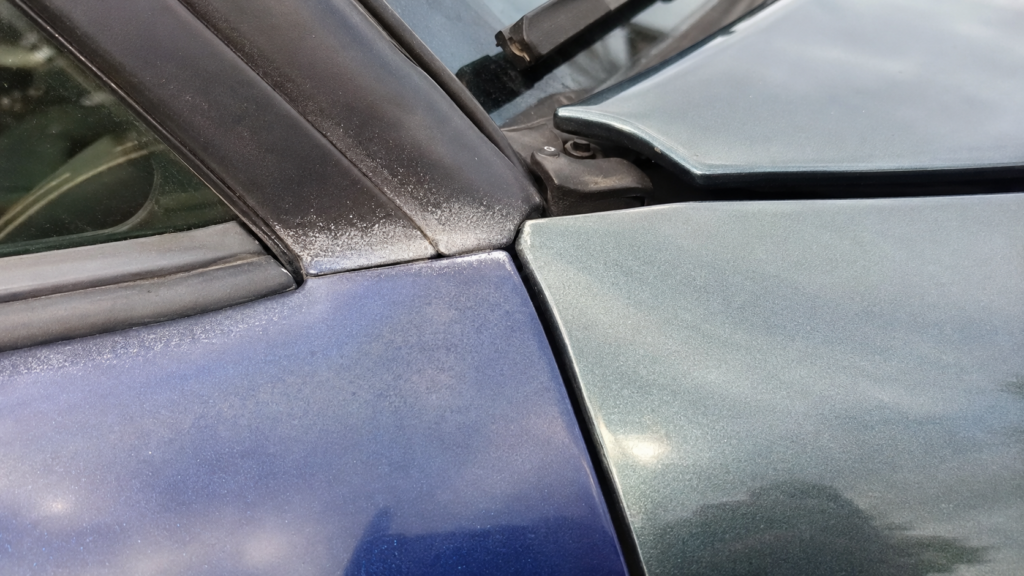 Poor paint match, overspray and uneven panel gap on a used car